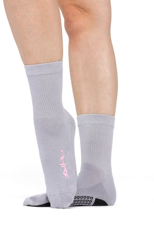 Side view of gray crew sock with pink birds sitting on a tree branch silk screened to the side of the foot.