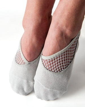 Light gray ankle height, scooped grip socks with a diagonal mesh panel extending from the outside of the ankle to the top of the toes.