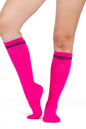 Pink knee high grip socks with two black stripes accenting the top of the sock.