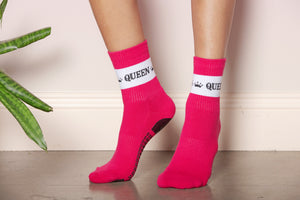 Close up shot of fuchsia crew socks with white stripe. Stripe accented with 'Pilates Queen' decorative text. 