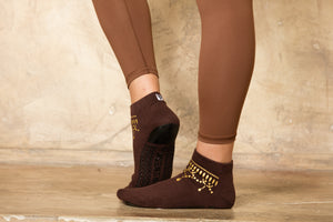 Side view of brown ankle sock with gold anklet silk screening.