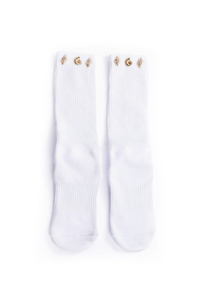 White socks with gold seashell accents along cuff on a white background.