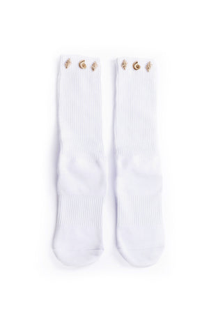 White socks with gold seashell accents along cuff on a white background.