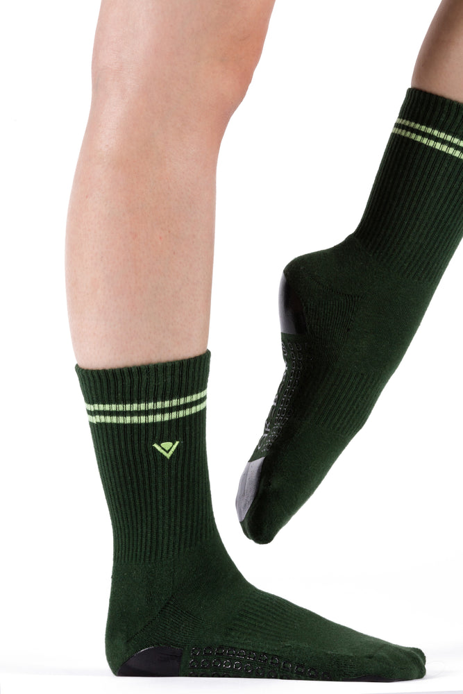 Hunter green crew socks with lime green stripe detailing at the top of the sock and embroidered Arebesk logo.