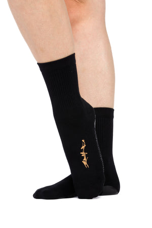 Side view of black crew sock with gold birds sitting on a tree branch silk screened to the side of the foot.