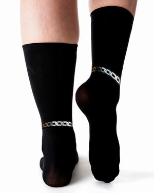 
            
                Load image into Gallery viewer, Back view of black sock with metallic chain detailing across ankle.
            
        